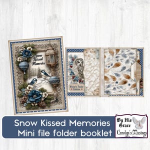 May include: A winter-themed mini file folder booklet. The cover displays a framed winter scene with blue accents, birds, and the text "Snow Kissed Memories." The booklet is open, showing pages with owl and leaf designs.