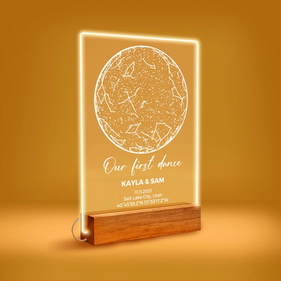 An LED-lit acrylic star map plaque showing the exact night sky on a date you choose — genuinely sentimental, visually striking, and the light-up stand makes it displayable art.