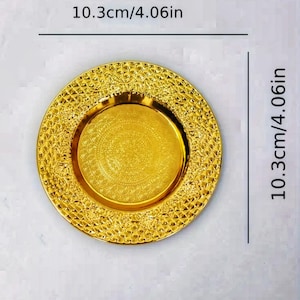 May include: A gold-colored decorative plate with an intricate embossed design. The plate measures 10.3 inches in diameter.