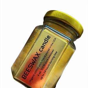 May include: A 4 ounce beeswax candle in a clear glass jar with a gold lid. The candle is hand-poured in the USA and has an organic cotton wick. It is estimated to burn for up to 24 hours.