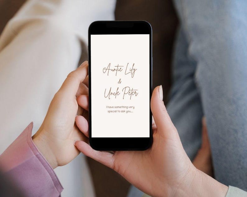 May include: A black smartphone screen shows cursive text on a cream background. The text reads "Auntie Lily & Uncle Peter" and below it, "I have something very special to ask you..."
