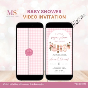 May include: Two smartphones displaying a digital baby shower video invitation with a pink gingham background. The screen shows text reading A LITTLE sugar plum IS ON THE WAY, Anne & Daniel, DECEMBER 16, and details for a baby shower event.