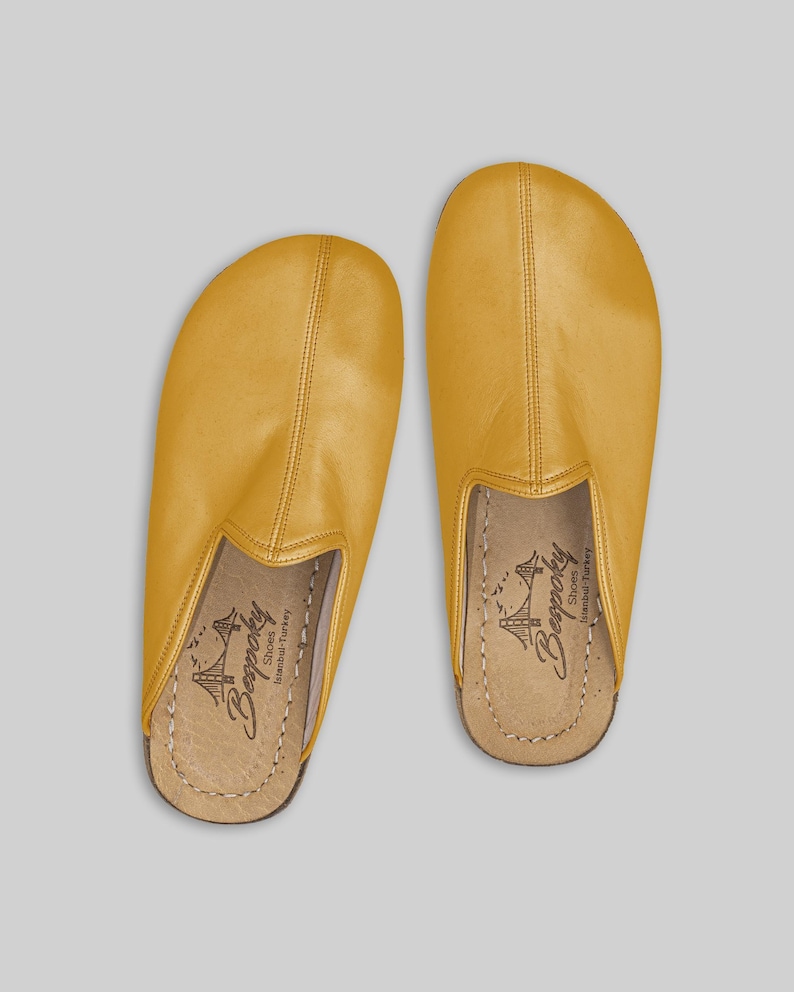 Men's mustard leather slip-on mules worn on foot, demonstrating the natural fit and wide toe box for ultimate barefoot comfort and healthy foot alignment.