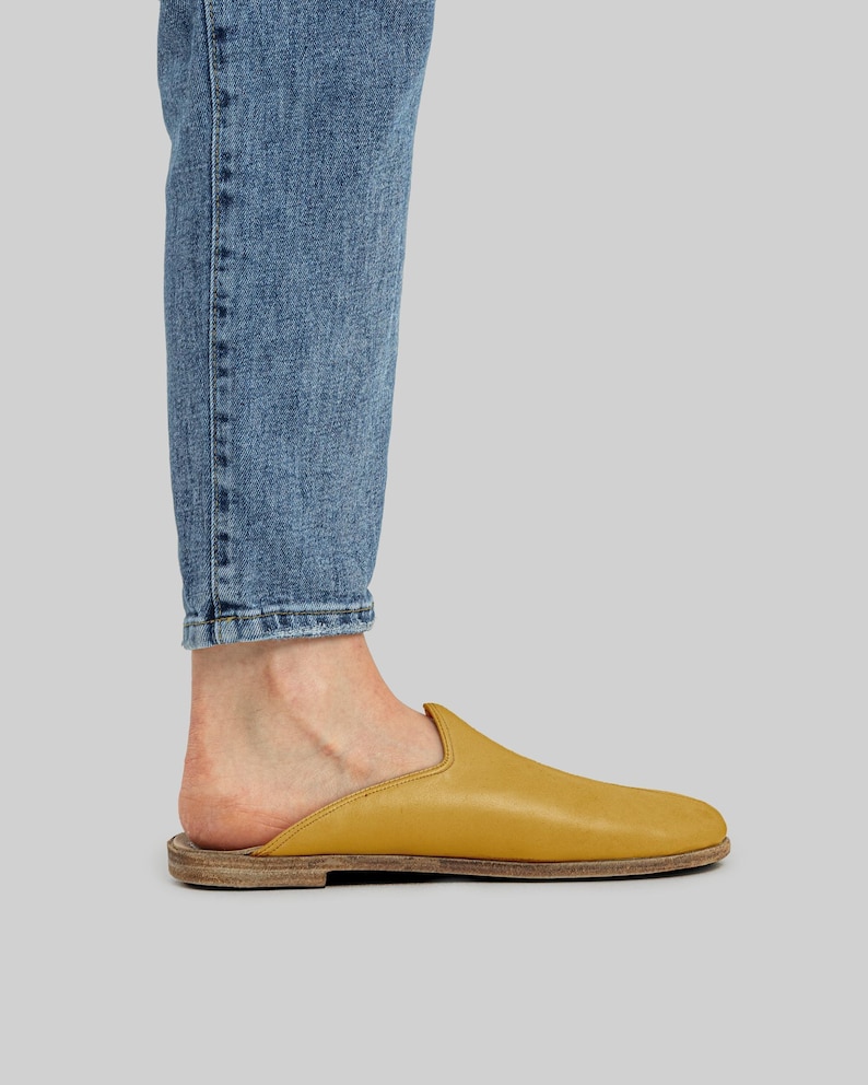 Side profile of men's handmade mustard leather mules, highlighting the flexible zero-drop sole and wide toe box design for natural foot alignment.
