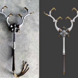 May include: A white and gold decorative weapon with a long handle and a skull-like head with three horns. The weapon has a black leather strap attached to the bottom.
