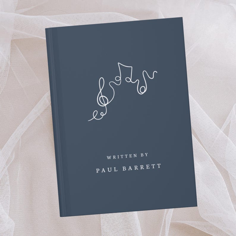 May include: A navy blue book with a minimalist white line drawing of musical notes on the cover. The text "WRITTEN BY PAUL BARRETT" is printed in a clean, sans-serif font at the bottom of the book.