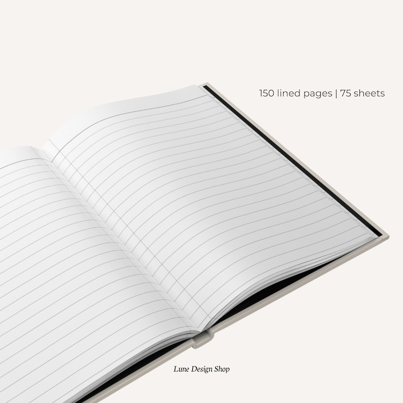 May include: A white lined notebook with a black spine and the text "150 lined pages | 75 sheets" printed on the cover. The notebook is open to reveal the lined pages. The text "Lune Design Shop" is printed on the bottom of the page.