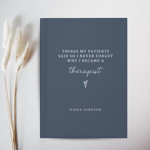 May include: A navy blue journal with white text that reads "THINGS MY PATIENTS SAID SO I NEVER FORGET WHY I BECAME A therapist" with a heart symbol and the name "KIERA JOHNSON".
