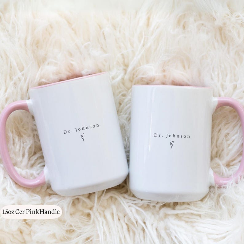May include: A set of three ceramic mugs with a speckled, matte finish. The mugs are in shades of cream, light gray, and dark gray. Each mug has a simple, minimalist design and a rounded handle.