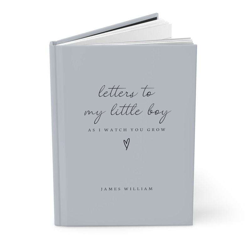 May include: A gray hardcover journal with the text "letters to my little boy as i watch you grow" and a small heart symbol. The name "JAMES WILLIAM" is printed below the text.