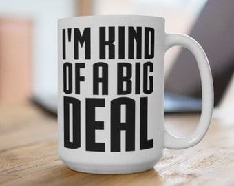 May include: White ceramic coffee mug with a black inscription that reads "I'm kind of a big deal".