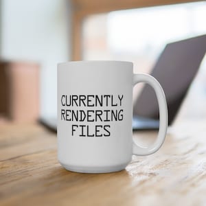 May include: White ceramic coffee mug with black text that reads "CURRENTLY RENDERING FILES".
