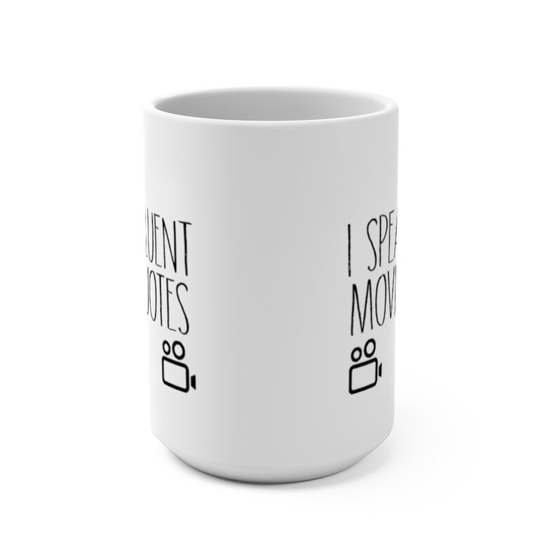 May include: White ceramic mug with black text that reads "I speak fluent movies" and a film camera icon on one side and "I speak fluent movies" and a film camera icon on the other side.