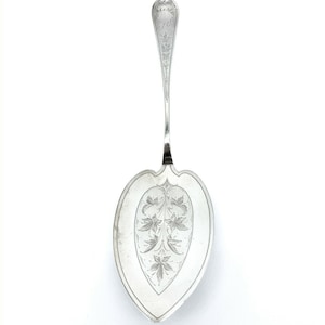 May include: A silver cake server with an ornate handle and a heart-shaped blade. The blade is decorated with an engraved floral design.