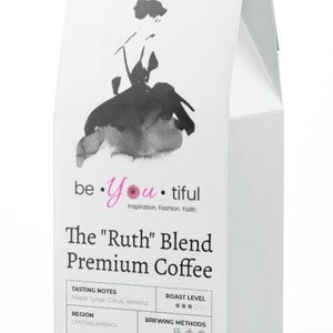 May include: White bag of The "Ruth" Blend Premium Coffee, 12 oz (340g), 100% ground coffee, with a black and white illustration of a woman on the front. The bag lists tasting notes of maple syrup, citrus, and almond, and a roast level of medium.
