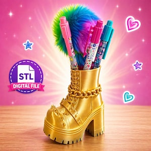 May include: A gold-colored boot-shaped pen holder with a chain and spike details, holding pens with floral designs and a colorful pom-pom. The pens are pink and teal. The image includes the text "STL DIGITAL FILE".