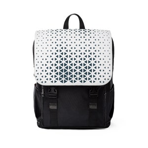 May include: A black backpack with a white and dark blue geometric pattern on the front flap. The backpack has adjustable straps and a zippered closure.