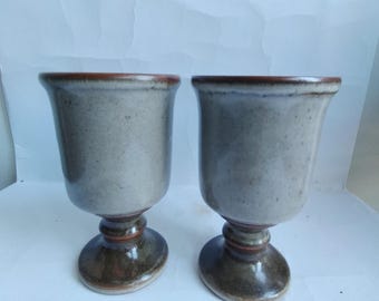 A pair of vintage rustic, sturdy stoneware goblets in earth tones
