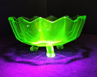 Small scalloped uranium glass bowl on three feet