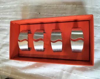 A set of four brushed steel napkin rings in original box, Danish