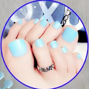 May include: Light blue toe nail wraps for a pedicure. The wraps are applied to the toes and look like painted nails.