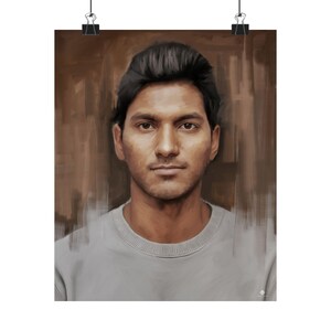 May include: A portrait print featuring a man with dark hair and a neutral expression. He is wearing a gray crew neck shirt. The background is a blend of brown tones, and the print is held by two black binder clips.