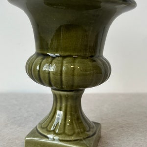 May include: A set of three ceramic vases in varying heights and shapes. The vases are glazed in a matte white finish, offering a minimalist aesthetic. The tallest vase is approximately 25 cm high.