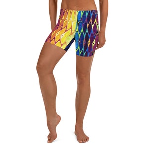 May include: A pair of athletic shorts with a colorful abstract pattern in shades of yellow, orange, blue, purple, and green. The shorts are made of a stretchy, comfortable fabric and are perfect for working out or running errands.