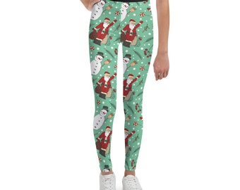 May include: Green leggings with a repeating pattern of Santa Claus and snowmen. The pattern is on a light green background with red, white, and brown accents.