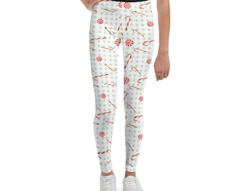 May include: White leggings with a repeating pattern of red and white candy canes and green peppermint candies.