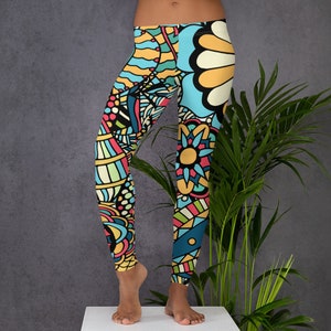 May include: Colorful leggings with a geometric and floral pattern in shades of blue, yellow, pink, and green.