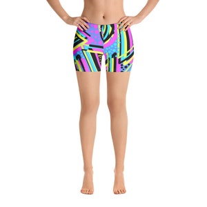 May include: Women's athletic shorts with a colorful geometric pattern in shades of pink, blue, yellow, and black.