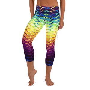 May include: A pair of colorful leggings with a swirling, psychedelic pattern in shades of yellow, orange, red, purple, blue, and green. The leggings are cropped and have a high waist.
