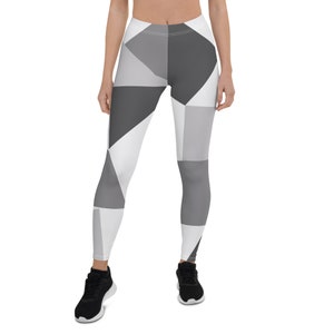 May include: Black and white geometric patterned leggings. The leggings have a white background with black geometric shapes.