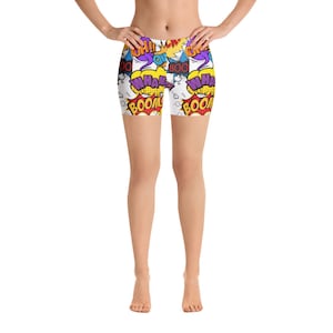 May include: White athletic shorts with a colorful comic book print featuring words like "BOOM", "WHAM", "OH!" and "BOO".