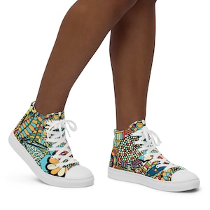 May include: High-top canvas shoes with a colorful, abstract pattern. The shoes have white laces and a white sole.