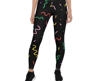 Puede incluir: Leggins negros con un patrón de confeti colorido de líneas onduladas y puntos.