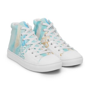 May include: A pair of white high-top canvas sneakers with a blue and yellow watercolor design. The design features abstract shapes and lines.