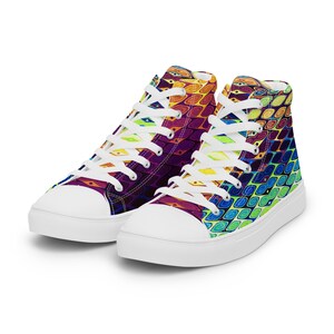 May include: A pair of high-top canvas sneakers with a colorful abstract pattern. The shoes are white with a white rubber sole and white laces.