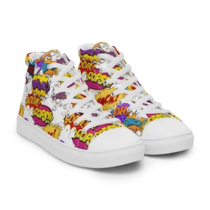 May include: White high-top canvas shoes with a comic book print featuring colourful speech bubbles with words like "BOOM!" and "POW!"