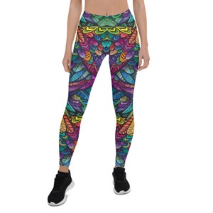 May include: Colorful leggings with a geometric pattern of feathers in shades of blue, green, yellow, orange, red, and purple.
