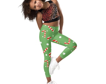 May include: Green leggings with a white and red candy cane pattern. The leggings are cropped and have a white dot pattern.