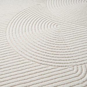 May include: Cream-coloured rug featuring a repeating pattern of curved lines. The lines create a textured surface with a soft, plush appearance. The design is a series of concentric arcs and straight lines, giving a modern, minimalist aesthetic.