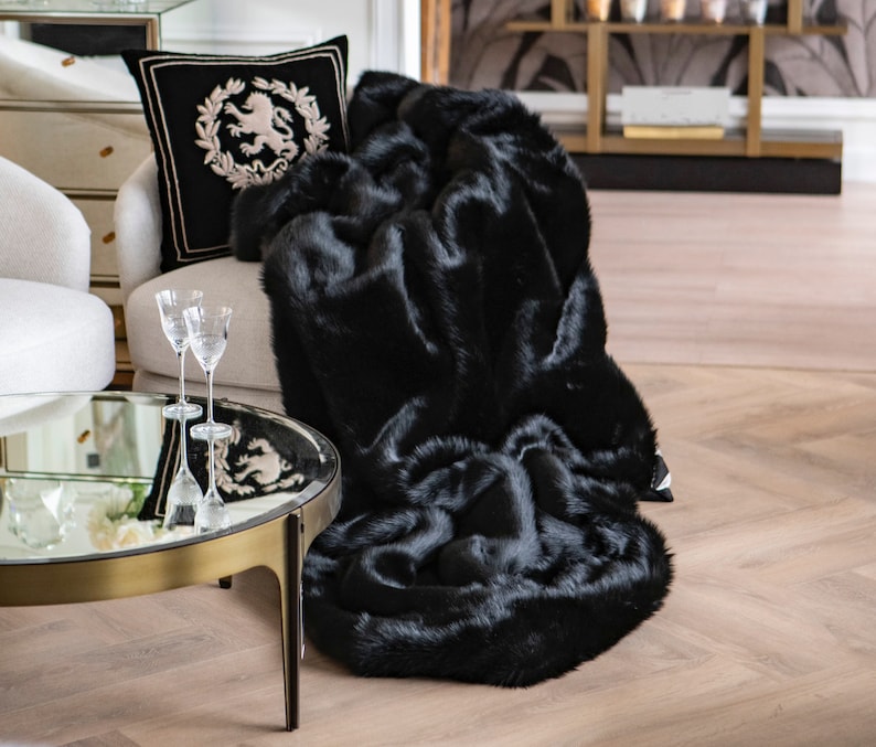 Exclusive Black Faux Fur Blanket – the perfect home decor accent uniting comfort and elegance. This unique blanket, crafted from soft faux fur in a deep black hue, is a luxurious home decoration ideal for contemporary settings and glamorous interiors. It provides warmth on cool evenings while elevating the prestige and designer charm of your living space.