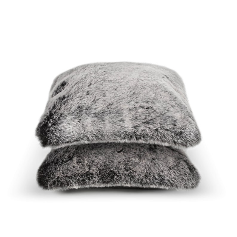 Two plush, silver pillows crafted from premium faux fur offer the perfect addition to your home decor. Ideal when paired with throws, they enhance your living spaces with a stylish blend of comfort, design, and elegance. Perfect for everyday relaxation or as a thoughtful gift, these modern accents elevate any room with a chic and contemporary feel.