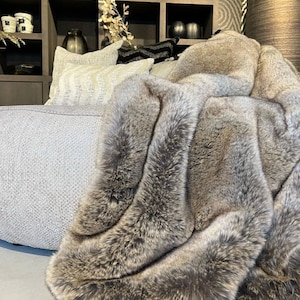 Gray Faux Fur Throw Blanket for Living Room – a symbol of comfort and elegance in interior design. This luxurious, fluffy faux fur blanket adds a modern accent to home decor, perfectly complementing minimalist arrangements. The perfect fusion of warmth and style makes this chic throw an essential element in any space, highlighting the comfort, design, and elegance of your interior.