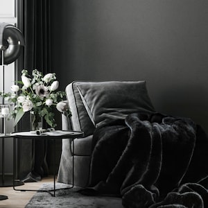 Create your own luxurious relaxation nook featuring an elegant velvet armchair in deep, dark tones paired with a chic black fur throw. This luxurious faux fur throw blanket made from high-quality synthetic fur is the perfect home decor accent.  Refined design, exceptional comfort, and timeless elegance. Perfect as a housewarming gift or a wedding gift for her.