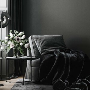 Create your own luxurious relaxation nook featuring an elegant velvet armchair in deep, dark tones paired with a chic black fur throw. This exclusive home decor set exudes refined design, exceptional comfort, and timeless elegance, making it the perfect accent for your interior space.