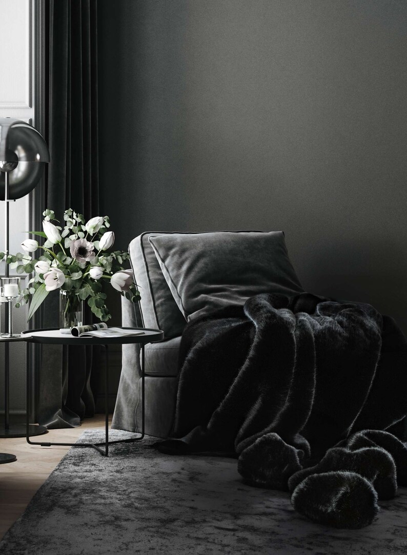 Create your own luxurious relaxation nook featuring an elegant velvet armchair in deep, dark tones paired with a chic black fur throw. This exclusive home decor set exudes refined design, exceptional comfort, and timeless elegance, making it the perfect accent for your interior space.