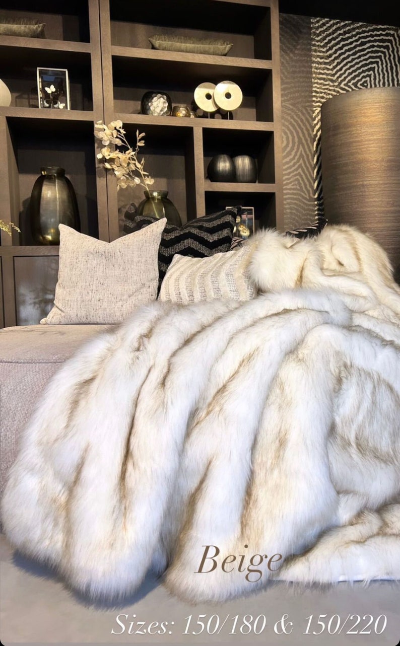 White faux fur blanket is the perfect home décor accessory, seamlessly blending comfort and elegance. This luxurious throw in creamy ivory tones enhances interior design, accentuating the chic style of modern niches. Choose our ultra-soft blanket to transform your space, adding a trendy accent and exceptional comfort to every home.